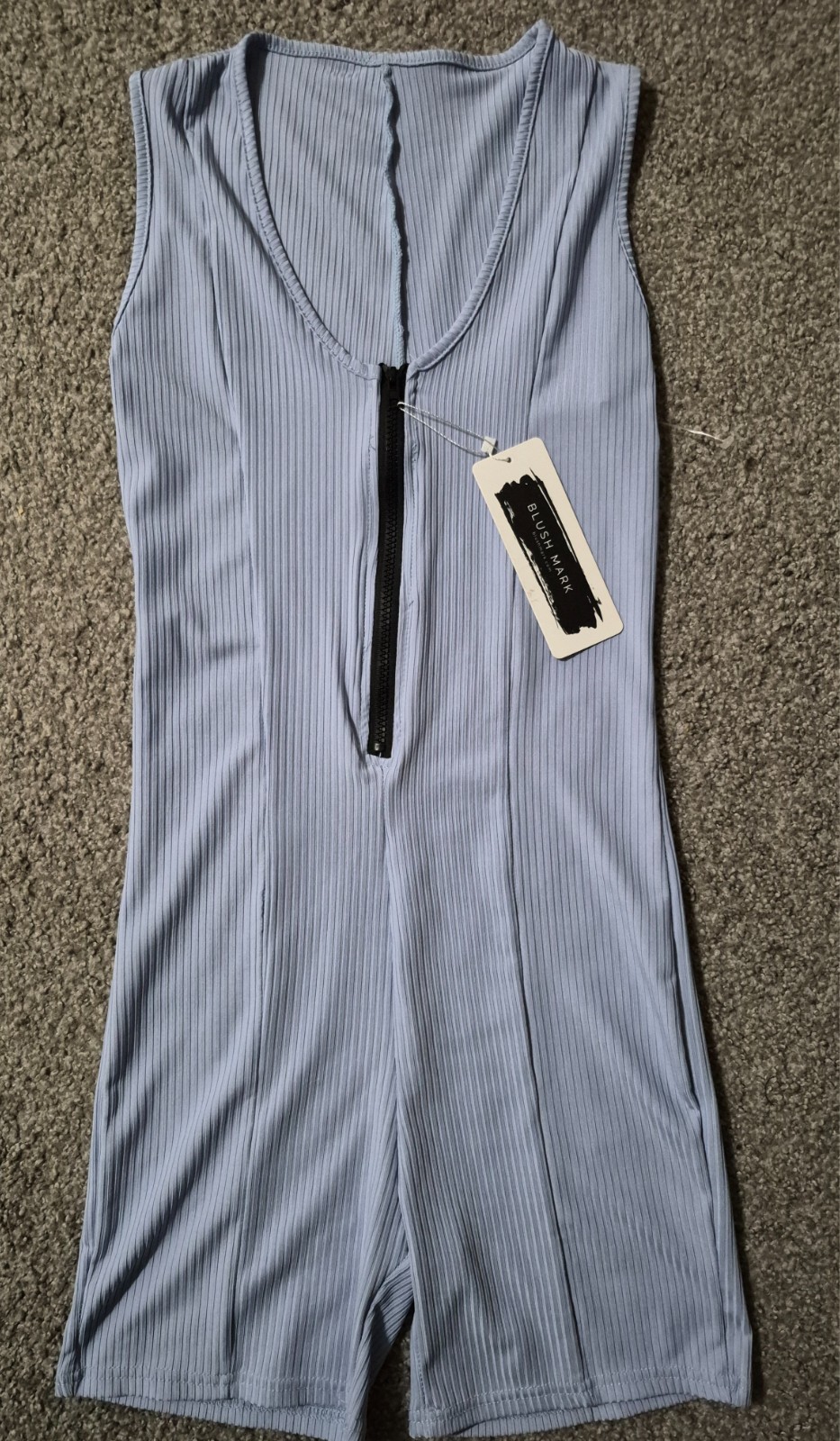 Blush Mark brand sleeveless ribbed romper size med a front zipper closure.
