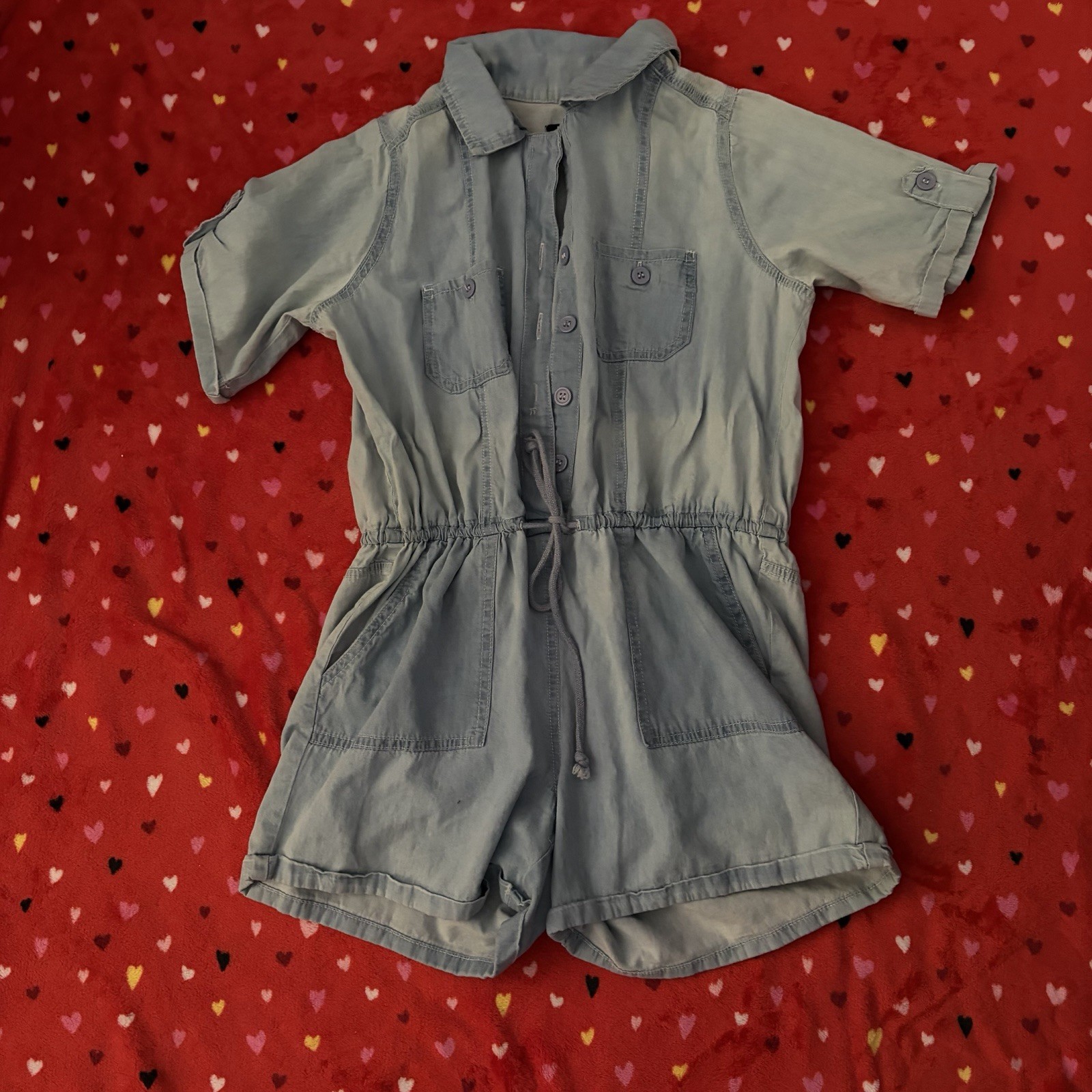 Light blue romper with adjustable drawstring waist and pockets. Size: S